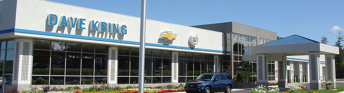 Exterior view of a commercial building featuring cast stone and limestone accents, with modern architecture and large windows.