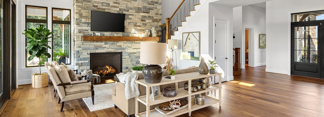Modern living room with a stone accent wall featuring manmade cultured veneer around a cozy fireplace.