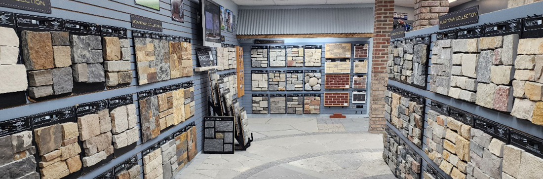 This image showcases the interior of The Concrete Service Showroom, highlighting a wide array of natural stone veneer displays. The showroom provides customers with the opportunity to explore different textures, colors, and styles of stone, perfect for enhancing both residential and commercial projects. The carefully curated displays allow you to see and feel the quality of the materials, making it easier to choose the ideal solution for your landscaping or construction needs. Visit us in Traverse City to experience the best in stone veneer, pavers, and other premium materials.